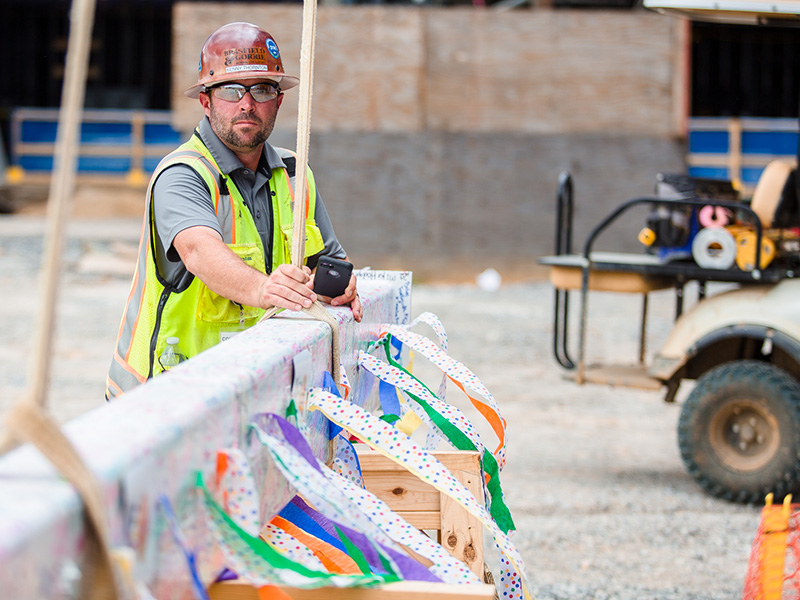 A beam covered with hundreds of signatures is prepared for a crane ride up to the seventh floor of UMMC’s pediatric expansion.